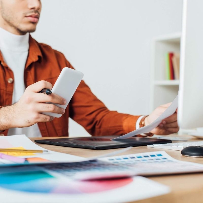 cropped-view-of-ux-designer-holding-smartphone-whi-2022-12-16-19-18-19-utc-1.jpg